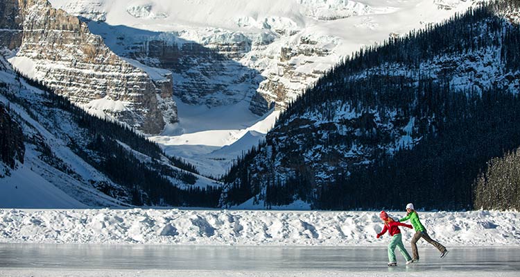 Two ice skaters on frozen Lake Louise