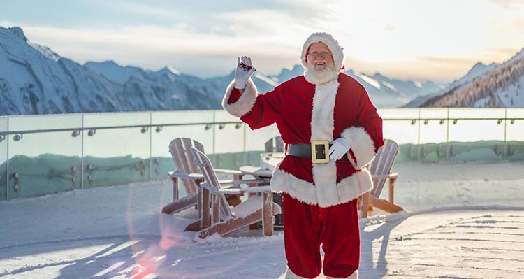 Santa Claus stands on the observation deck of the Banff Gondola