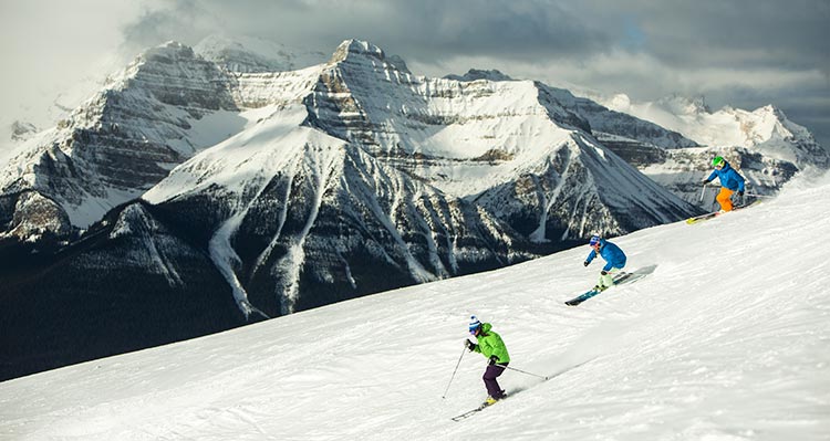 Three skiers on a snowy mountainside.