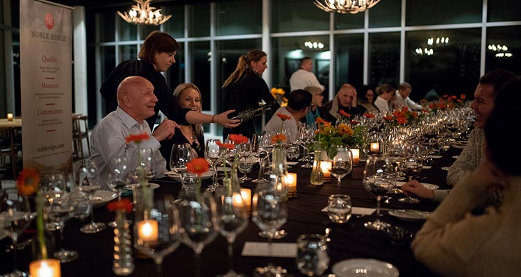 A long table with people sitting, ready for dinner.