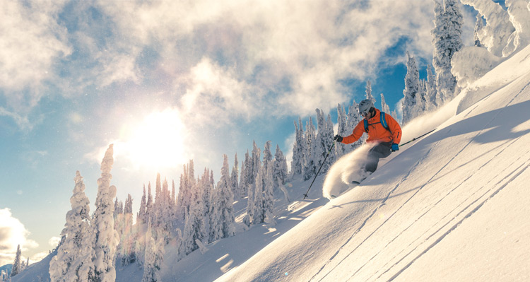 A person downhill skiing in the Rocky Mountains