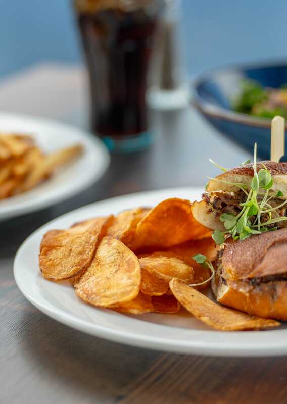 A window-side table with sandwiches.