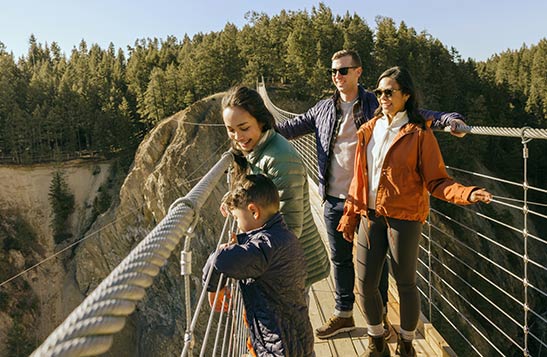 Parents and their two children walk along the Golden Skybridge