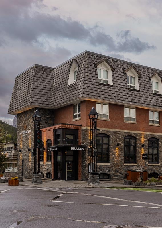 The exterior of a hotel at a street corner.