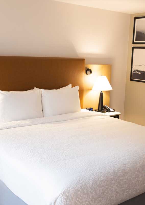 A bed in a hotel room.