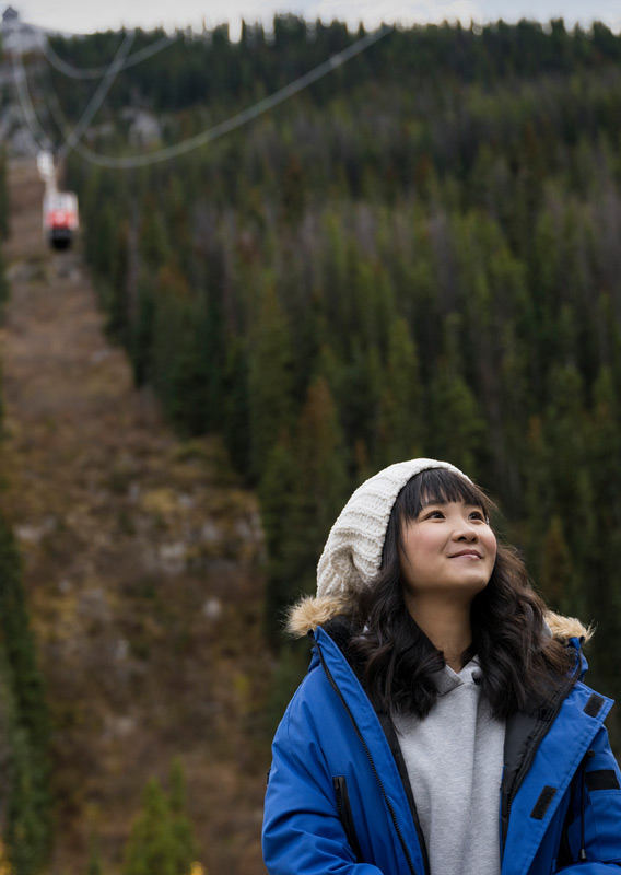 Person standing at the base of Jasper SkyTram with the Tram above