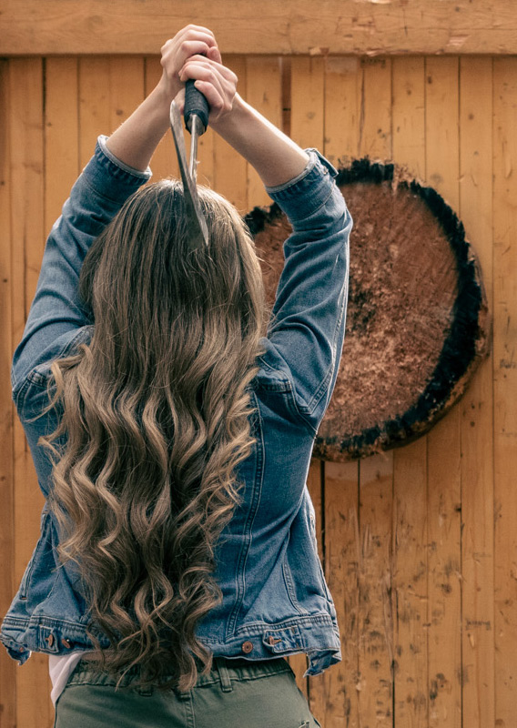 A couple axe throwing at Golden Skybridge.