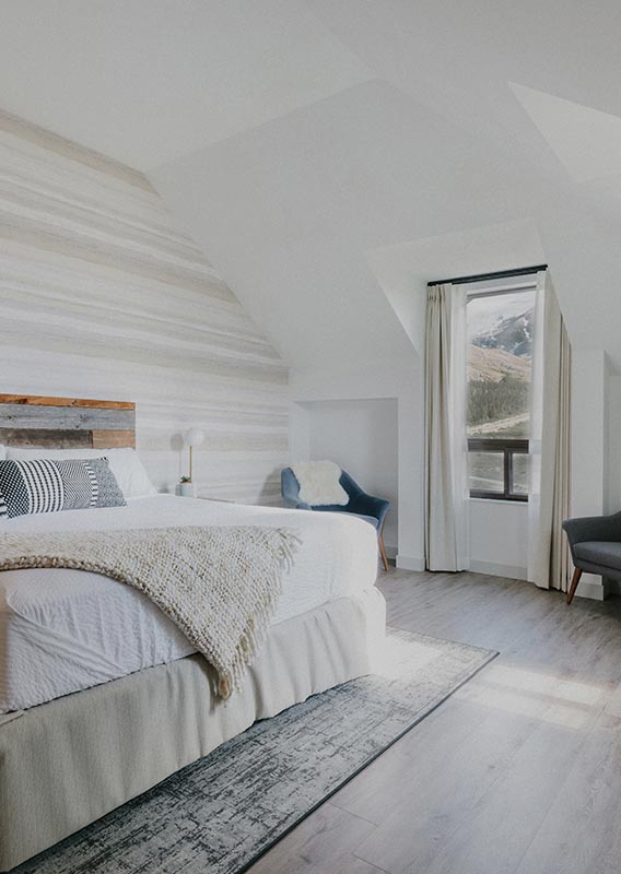 The inside of a hotel room with a king bed.